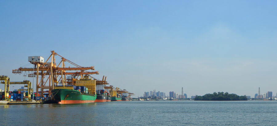 Container ships and port cranes in Vietnam illustrating the country’s growing role in global logistics and supply chain operations.