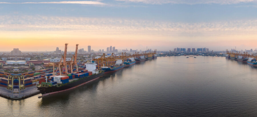 Container ships, cranes and cargo yards at a busy seaport in Vietnam.