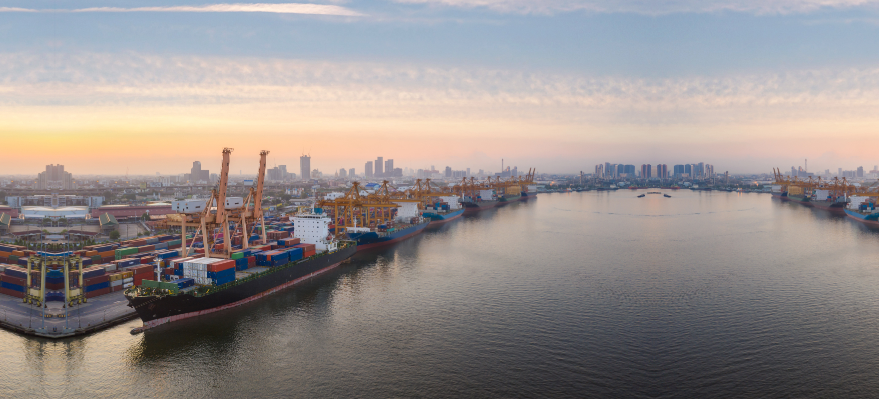Container ships, cranes and cargo yards at a busy seaport in Vietnam.